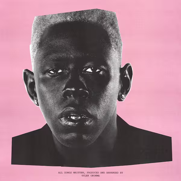 Monochrome photo of Tyler, the Creator staring at the camera, surrounded by a pink background.