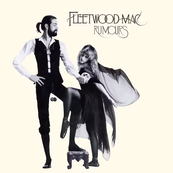 A grayscale view of Mick Fleetwood and Stevie Nicks standing together in front of an off-white background.
